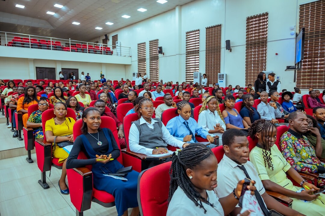 People gathered in a modern conference hall for civic discussion